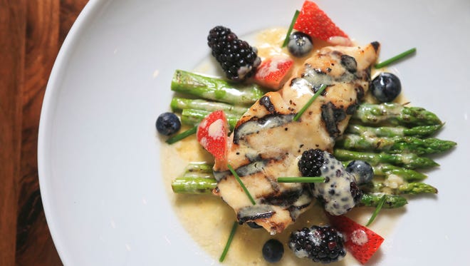 Grilled grouper with lemongrass finer beurre blanc, fresh berries and grilled asparagus from Brendon's Catch 23 and prepared by chef Ray Ramirez.