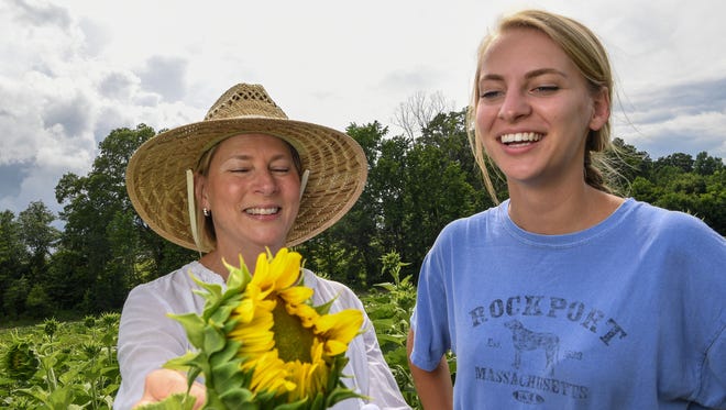 Danielle Roberts, left, and her daughter Caroline Roberts in the Sol Flower field in Anderson. Starting last year, Sol Flowers raised over $9,000 for Foothills Foundation in Anderson selling the flower they feel is good for the soul.