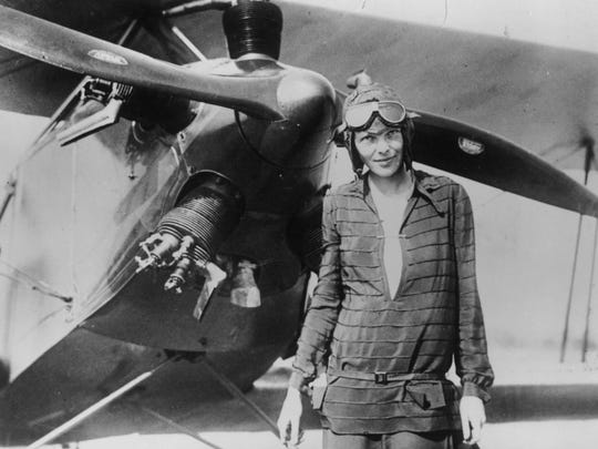 Amelia Earhart  in front of her bi-plane called "Friendship"