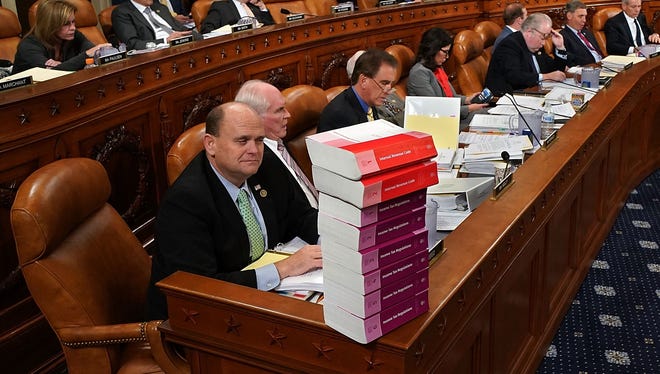 House Ways and Means Committee member Rep. Tom Reed, R-Corning, keeps a stack of books that document the current federal tax code and related regulations on his desk during the first markup of the proposed GOP tax reform legislation Nov. 6 on Capitol Hill in Washington, D.C.