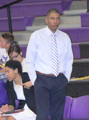 Matt Enriquez looks on while coaching a game for the Lady Mustangs this past season.