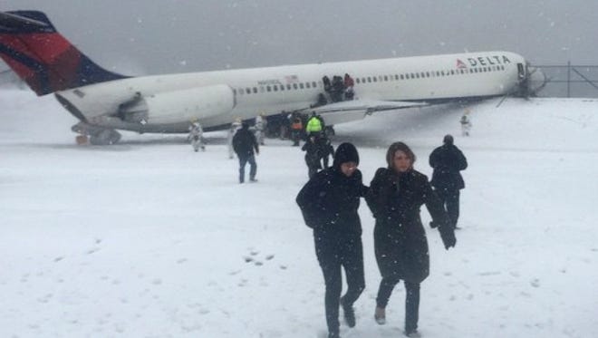 Passengers are evacuated after Delta Flight 1086 skidded off the runway at LaGuardia Airport during a snowstorm on March 5, 2015, in New York.