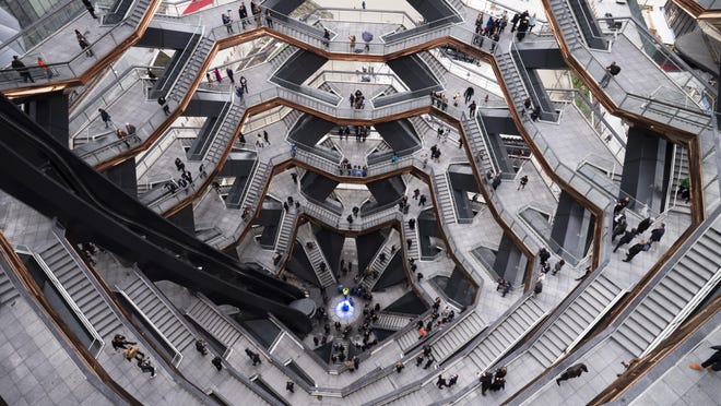 Visitors to "Vessel" climb its staircases on its opening day at Hudson Yards, Friday, March 15, 2019, in New York. Hudson Yards, a $25 billion urban complex on Manhattan's west side, is the city's most ambitious development since the rebuilding of the World Trade Center.