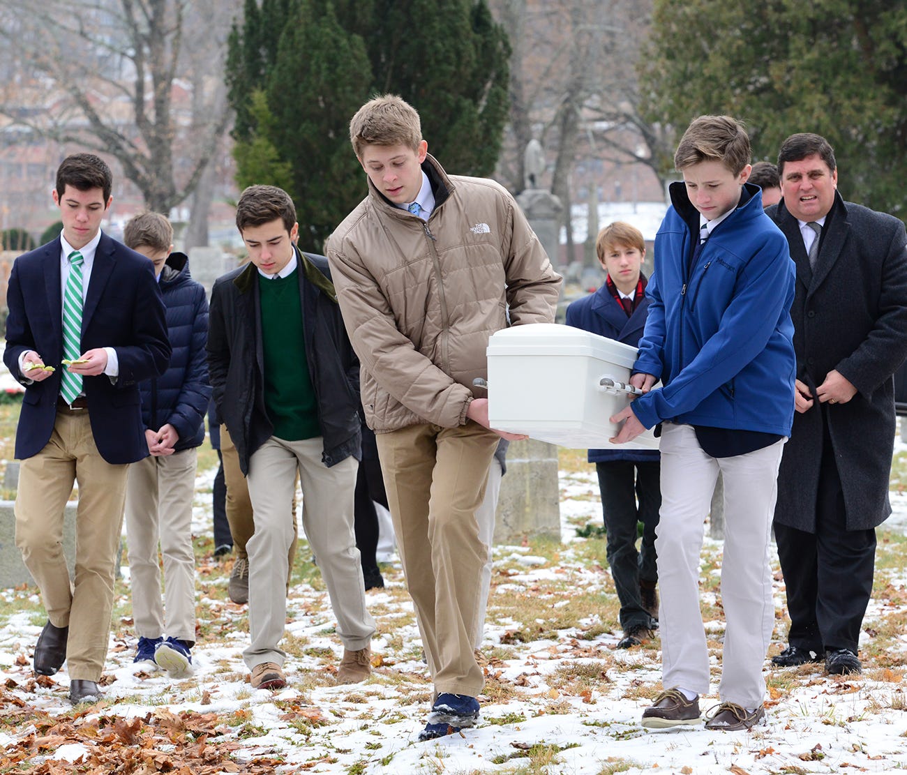 John Manahan and Finn Gannon carry the casket to the gravesite for the funeral services of a stillborn baby found abandoned in a Mine Hill recycling center in October.