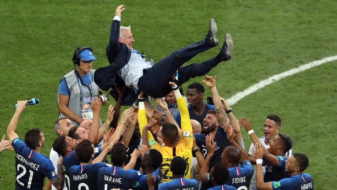 French players throw France head coach Didier Deschamps into the air celebrating at the end of the final match between France and Croatia at the 2018 soccer World Cup in the Luzhniki Stadium in Moscow, Russia, Sunday, July 15, 2018. (AP Photo/Thanassis Stavrakis)