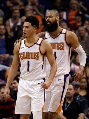 Phoenix Suns guard Devin Booker (1) gets held back by Tyson Chandler after getting called for a technical foul against the Indiana Pacers in the second half during an NBA basketball game, Sunday, Jan. 14, 2018, in Phoenix. The Pacers defeated the Suns 120-97.