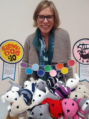 Cynthia Petrovits is shown with her “glove dog stuffies.”