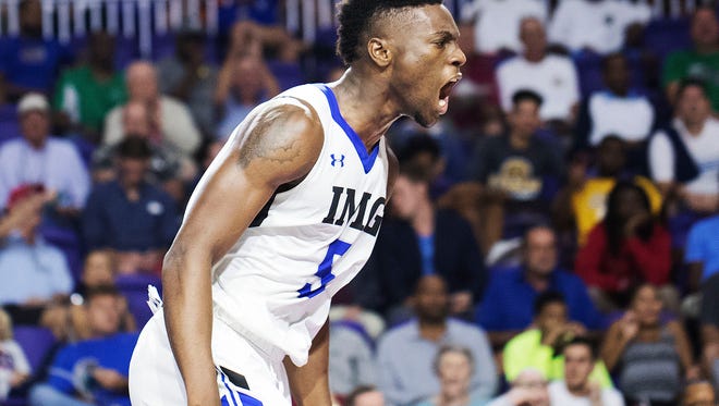 IMG Academy’s Emmitt Williams reacts after a dunk during a quarterfinal game against the Neuman Goretti at the Culligan City of Palms Classic at the Suncoast Credit Union arena on Monday. IMG won 71-56.