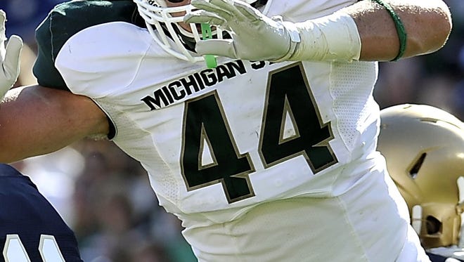 Michigan State defensive end Marcus Rush pressures Notre Dame QB Tommy Rees in 2011.