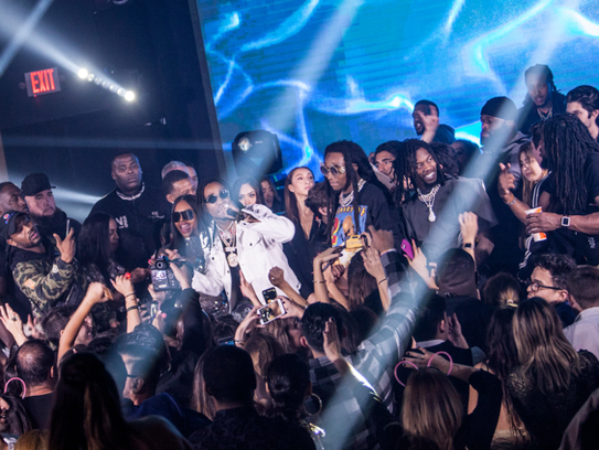 The Henry family stands onstage with Migos while they