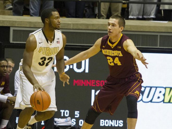 Feb 5, 2014; West Lafayette, IN, USA; Purdue Boilermakers forward Errick Peck (32) dribbles the ball in the first half and is guarded by Minnesota Golden Gophers forward Joey King (24) at Mackey Arena. Mandatory Credit: Trevor Ruszkowski-USA TODAY Sports