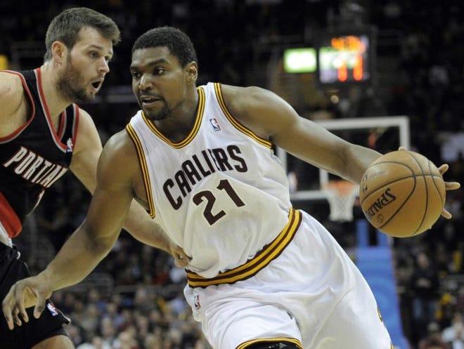 Dec 17, 2013; Cleveland, OH, USA; Cleveland Cavaliers center Andrew Bynum (21) drives against Portland Trail Blazers center Joel Freeland (19) in the fourth quarter at Quicken Loans Arena. Mandatory Credit: David Richard-USA TODAY Sports
