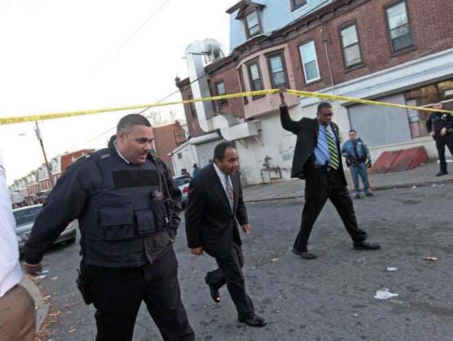 
Mayor Dennis Williams leaves the scene where a Delaware State Police officer was shot Nov. 20, 2013.
