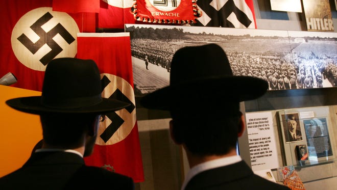 Ultra-Orthodox Jews look at an exhibit on Adolf Hitler and the Nazi rise to power at the Yad Vashem Holocaust Memorial Museum in Jerusalem. As the Orthodox community in Lakewood, N.J., grows along with the time since the Holocaust, some teens in the area are showing admiration for Hitler and disdain for Jews.