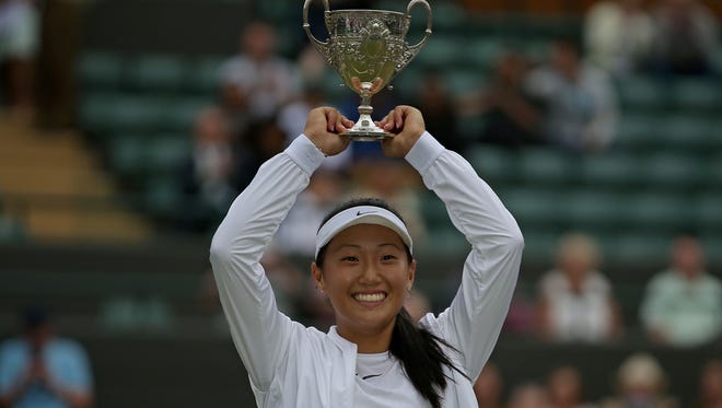 Thousand Oaks' Claire Liu holds the trophy after winning the Wimbledon junior title in the summer.