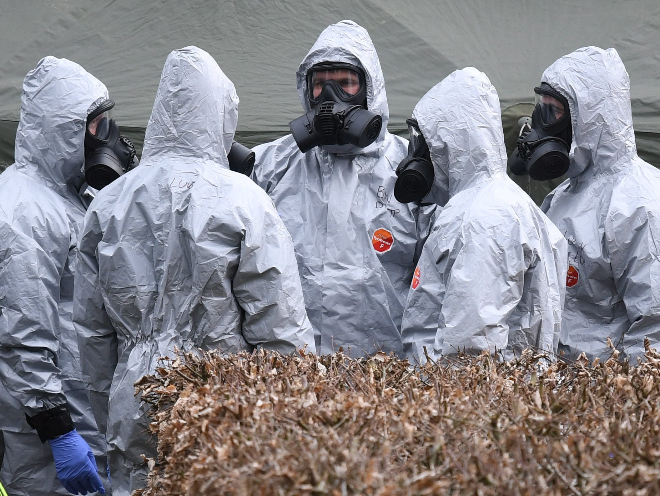 Military in protective clothing prepare to remove vehicles from a car park in Salisbury, Britain, March 11, 2017.