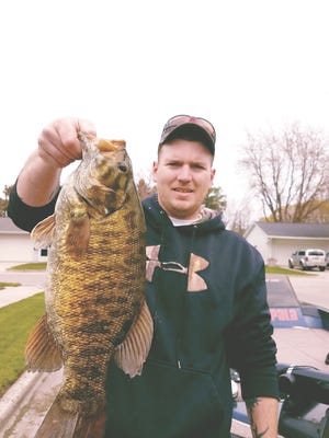 Manitowoc native Nick Glaeser was fishing not far from Manitowoc on a Lake Michigan tributary May 10 when he caught this smallmouth bass. The smally was 23 inches long and weighed 7 pounds, making it a once-in-a-lifetime fish.