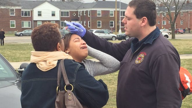 A student from Detroit's Central Collegiate Academy is treated for what appeared to be exposure to a chemical spray outside the school Tuesday afternoon.