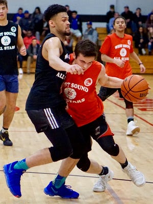 Olympic's Jaiden Mosley defends North Kitsap's Zac Olmsted during Tuesday's West Sound Senior All-Star Basketball doubleheader at Olympic College.