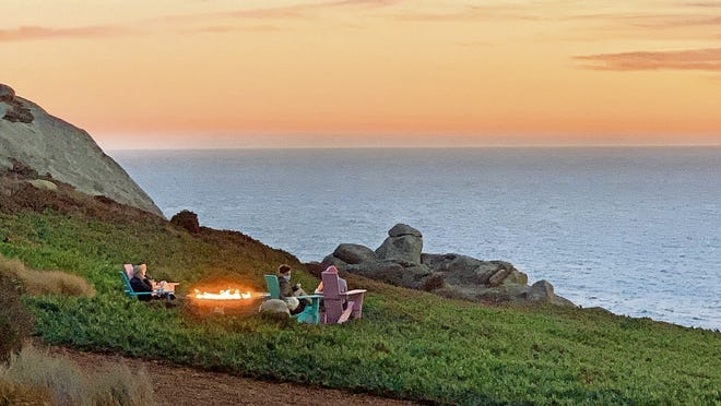 Lounging by the firepit at sunset at Timber Cove Resort in Jenner, California.