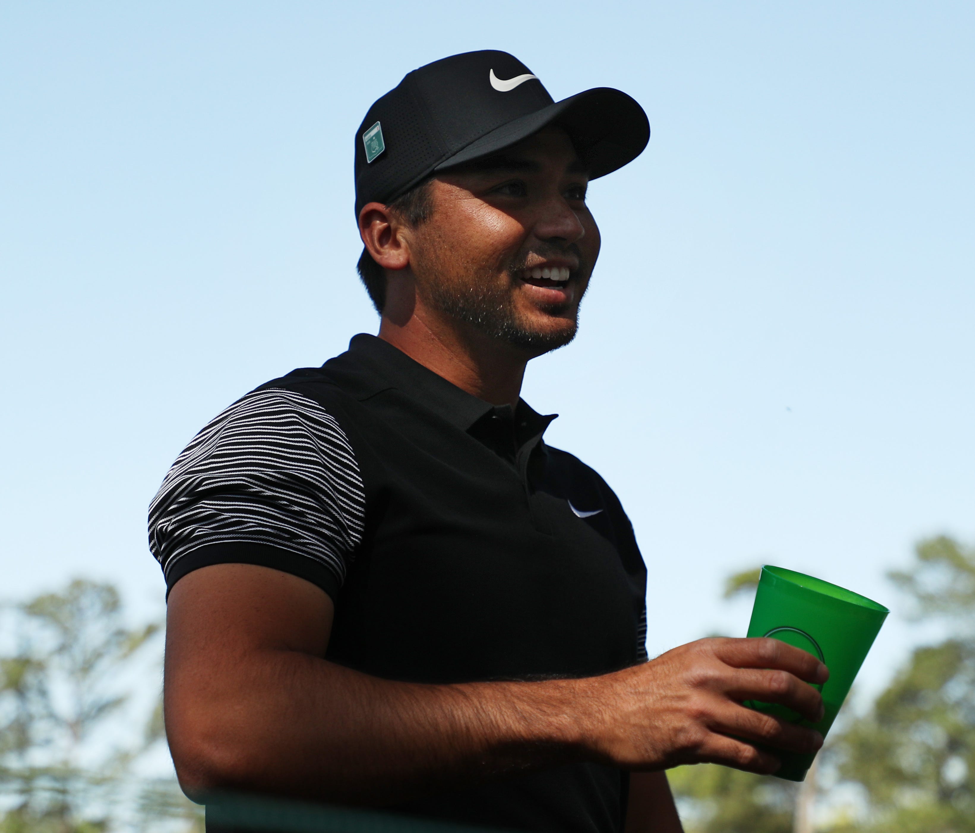 Jason Day of Australia talks with a patron after his shot landed in the patron's beverage during the first round of the 2018 Masters Tournament at Augusta National Golf Club on April 5.