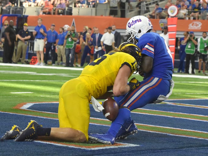 Michigan's' Chase Winovich knocks the ball out of Florida