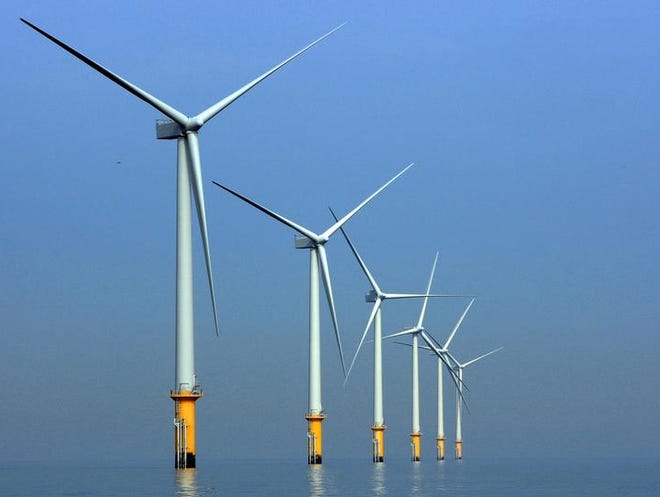 LIVERPOOL, UNITED KINGDOM - MAY 12:  Turbines of the new Burbo Bank off shore wind farm stand in a calm sea in the mouth of the River Mersey on May 12, 2008 in Liverpool, England. The Burbo Bank Offshore Wind Farm comprises 25 wind turbines and is situated on the Burbo Flats in Liverpool Bay at the entrance to the River Mersey, approximately 6.4km (4.0 miles) from the Sefton coastline and 7.2km (4.5 miles) from North Wirral. The wind farm is capable of generating up to 90MW (megawatts) of clean, environmentally sustainable electricity. This is enough power for approximately 80,000 homes. The site is run by Danish energy company Dong Energy.  (Photo by Christopher Furlong/Getty Images)