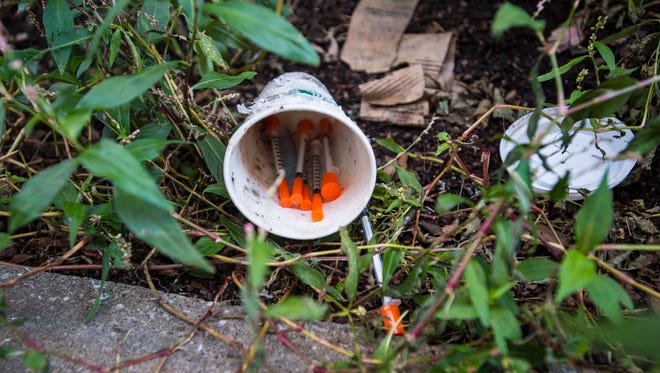 Discarded needles lie on the ground in an alley next to the Lakeview parking college in Burlington on Monday.