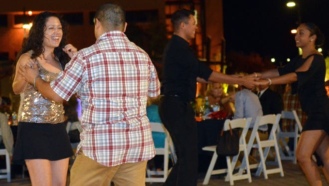Adriana Garcia and Jaime Ponce (left) enjoy dancing to Salsa Music Friday night at the private dinner opening up the Salsa Fest this weekend at the Downtown Plaza.  Photo taken 9/30/16.