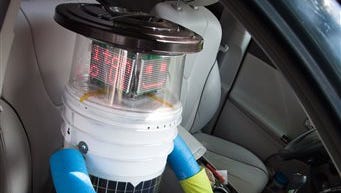 This undated photo made available by Ryerson University in Toronto on Thursday, Aug. 14, 2014 shows hitchBOT in a car. The talking robot that's been hitchhiking rides from strangers to travel from Canada's east to west coast is nearing the end of its journey. Its final destination is Victoria, British Columbia, Canada which its creators expect it to reach by Aug. 17, 2014.