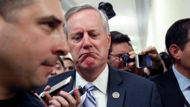 House Freedom Caucus Chairman Rep. Mark Meadows, R-N.C. reacts to a reporters question on Capitol Hill in Washington, Thursday, March 23, 2017, following a Freedom Caucus meeting. Just a few months ago, Republicans were cheering their good fortune, an all-Republican monopoly in Washington and the opportunity to push a conservative agenda to remake the federal government. After the health care vote, it’s clear winning can’t overcome the deep divisions in their ranks.  (AP Photo/Alex Brandon)