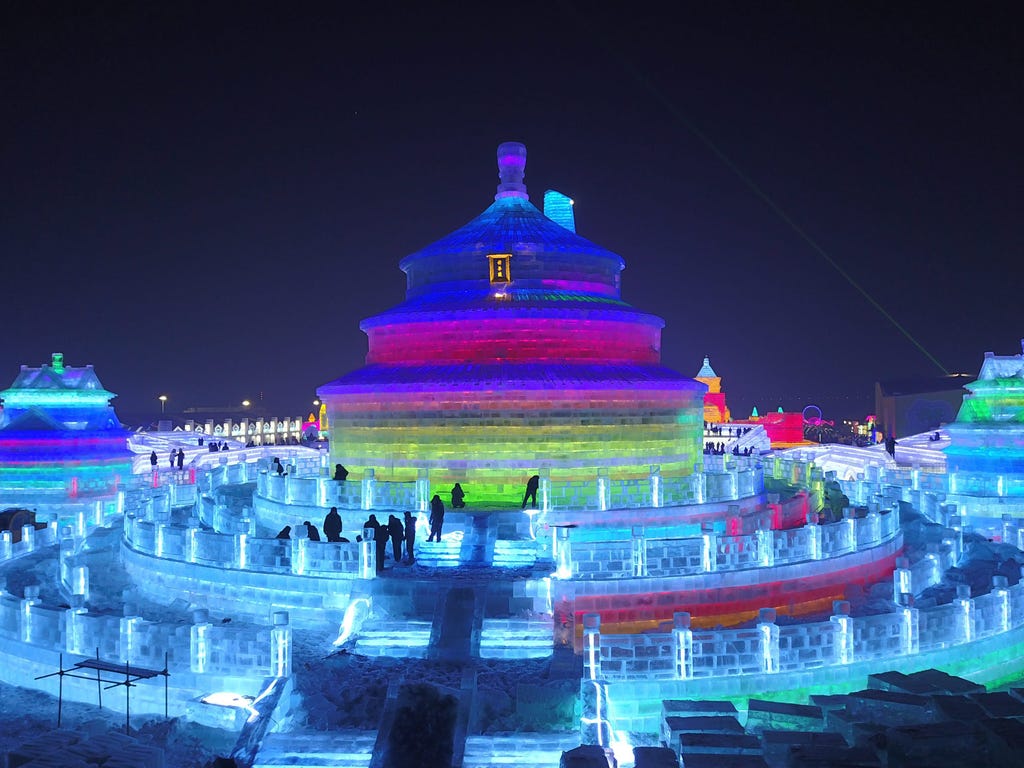 People tour between the large-scale ice sculptures at the 18th Harbin Ice and Snow World during its trial run opening to the public on Dec. 21, 2016, in Harbin city, Heilongjiang province, China.