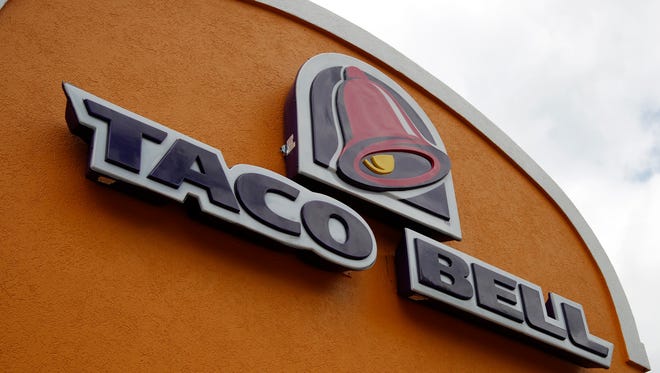 FILE - This Friday, May 23, 2014, file photo shows a sign at a Taco Bell in Mount Lebanon, Pa.