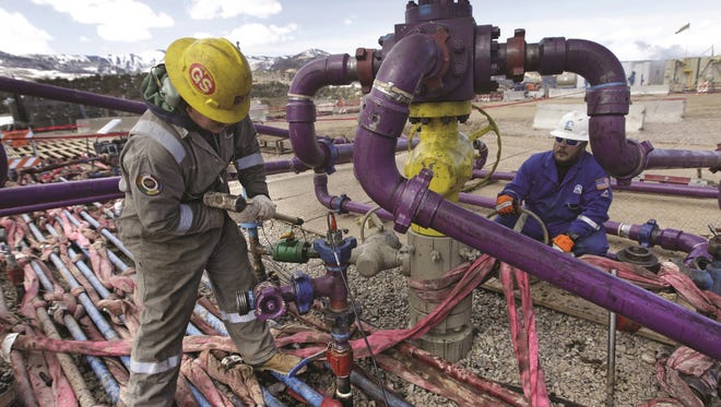 Workers at a natural gas well.