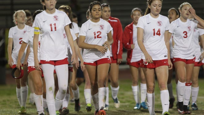 Dejected Palm Desert High School players walk back after losing their CIF Game 1-0 to California High School of Whittier at Palm Desert. 