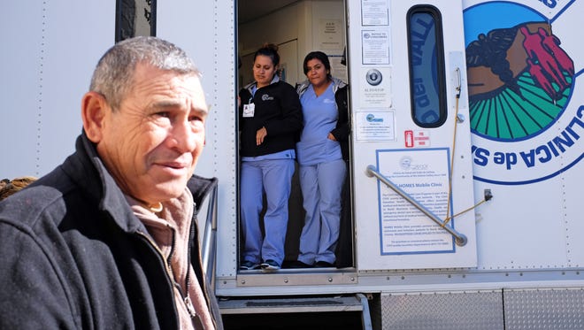 Matias Posadas, left, and CSVS staff members Lorena Martinez and Sadie Lopez at the door of the free mobile health van on Tuesday at the First United Methodist Church in Salinas. 
