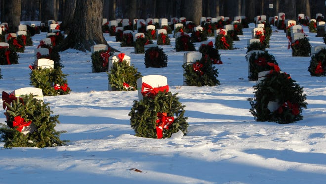 Volunteers decorated the veterans' headstones at the Indiana Veterans Home in West Lafayette in December 2016. The decorations are part of Wreaths Across America, which seeks to honor veterans by placing a wreath at their graves. Gold Star Mothers of Lafayette is accepting donations so that the veterans' headstones will be decorated this year.