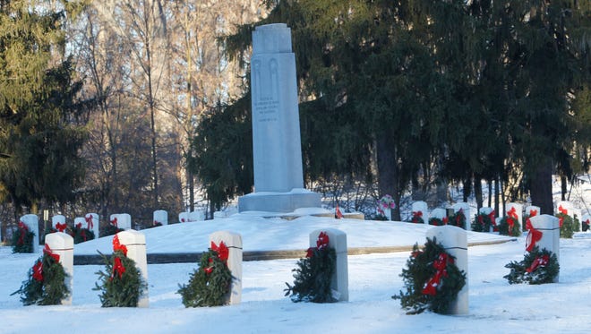 Volunteers braved the ice and cold over the weekend to decorate the veterans' headstones at the Indiana Veterans Home in West Lafayette. The decorations are part of Wreaths Across America, which seeks to honor veterans by placing a wreath at their graves.
