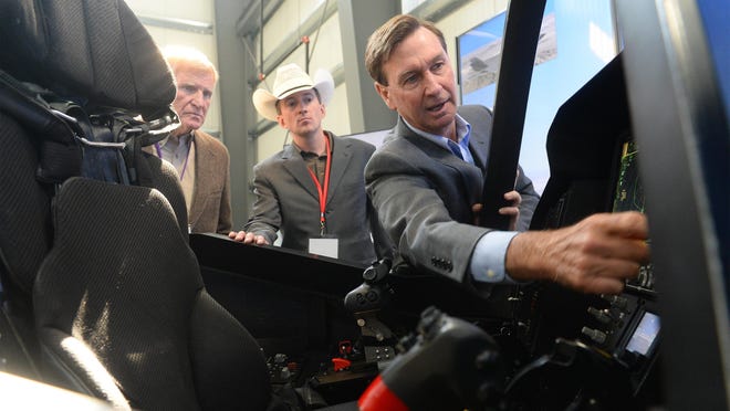 Gary Hentz, Lockheed Martin's Director of Tactial Aviation, use a cockpit demonstrator to give a tour of the armed forces newest joint strike fighter, the F-35 Lightening II, at Pioneer Aerostructures on Wednesday in Helena.