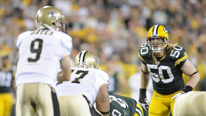 Green Bay Packers linebacker A.J. Hawk (50)stares down New Orleans Saints quarterback Drew Brees (9) during the 2011 season opener at Lambeau Field.