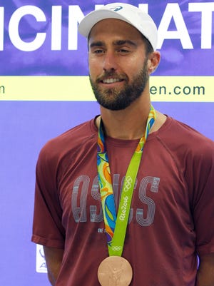Olympic bronze medalist Steve Johnson shows his medal to the media during the Western and Southern Open on Monday.