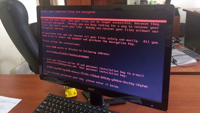 A computer screen cyberattack warning notice reportedly holding computer files to ransom, as part of a massive international cyberattack, at an office in Kiev, Ukraine, Tuesday June 27, 2017.