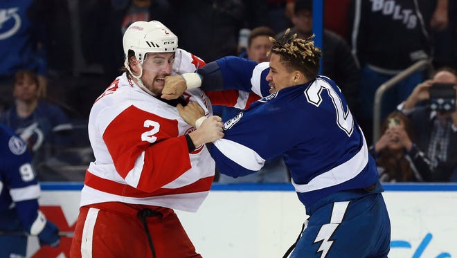 Detroit Red Wings defenseman Brendan Smith (2) and Tampa Bay Lightning right wing J.T. Brown fight March 22, 2016, at Amalie Arena.