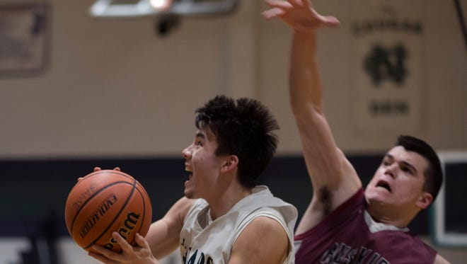 Colts Neck’s Brendan Clarke goes up with shot as Matawan’s Joe Beukers tries to block it. Matawan boys basketball vs Colts Neck in SCT game at Colts Neck, NJ. on February 13, 2017.