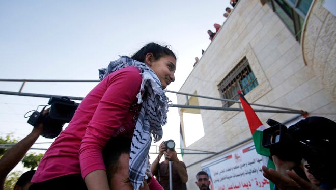 Palestinian Dima al-Wawi, 12, was jailed after she confessed to planning a stabbing attack on Israelis in a West Bank settlement. Here she returns to her home in Halhoul village, near the West Bank city of Hebron, after her release from an Israeli prison on April 24, 2016.
