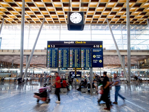 Passengers make their way to flights at Oslo Gardermoen