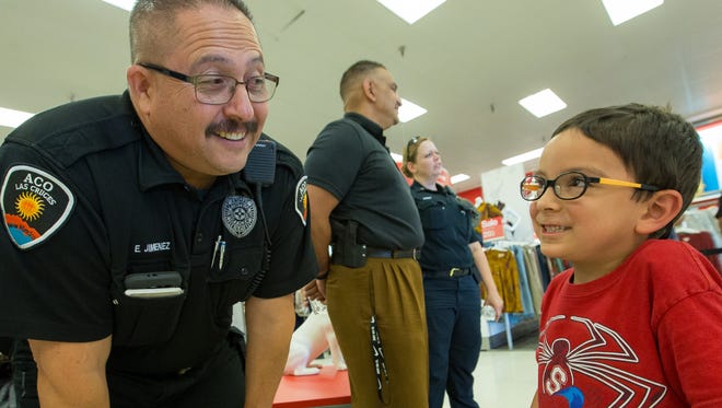 Kephas Garcia, 5, of Las Cruces, talks with Las Cruces Animal Control Supervisor Gino Jimenez on Saturday July 29, 2017. Garcia, who wants to be a police officer when he grows up, talked with many of the officers at Target during the Coffee with a Cop event. Coffee and snacks were provided to all courtesy of Target and Starbucks.