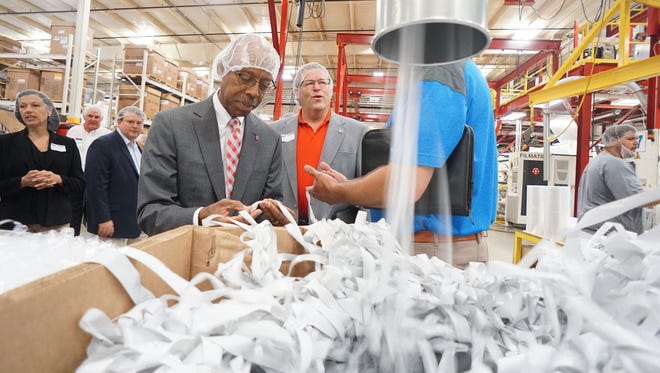 Ohio State University President Michael Drake examines the manufacturing process at Next Generations Films on Wednesday morning.