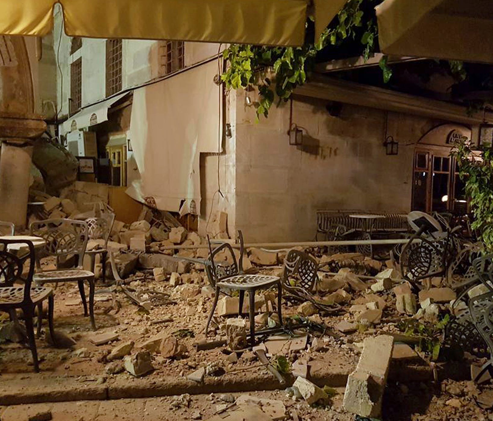 A cafe setting is littered with rubble following a strong earthquake on the Greek island of Kos early Friday, July 21, 2017.