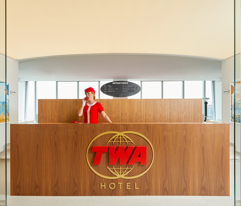 The TWA Lounge's reception desk modeled after Jet Age city center TWA ticket counters created by iconic mid-century industrial designer Raymond Loewy.